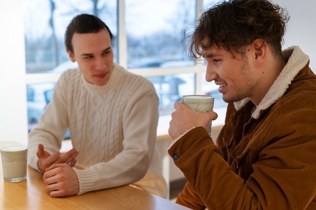 A close-up shot of two individuals deeply engaged in conversation during a coffee break at a podcasting conference. They are exchanging ideas and contact information, illustrating the personal connections formed at these events.