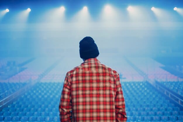 A person standing on a stage, illuminated by a spotlight, confidently addressing a large audience. The backdrop displays various logos of well-known podcasts, and the person is holding a microphone, symbolizing their unique value proposition in the podcasting industry.